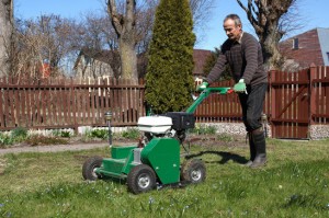 man aerating a lawn